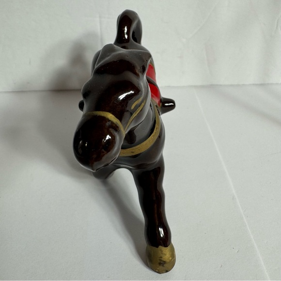 Vintage small brown ceramic horse figurine featuring gold trim and a red saddle. - Picture 3 of 10